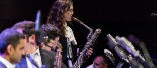 A group of students in the MSM Jazz Orchestra of the Manhattan School of Music in performance, with a saxophonist giving a solo