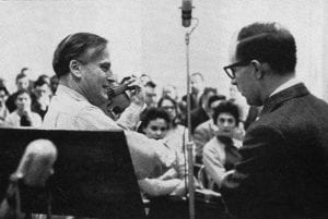 man with violin in front of crowd