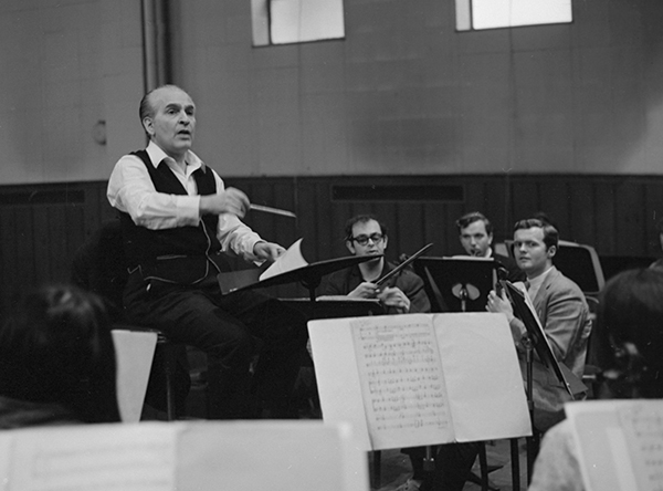 man conducting orchestra rehearsal