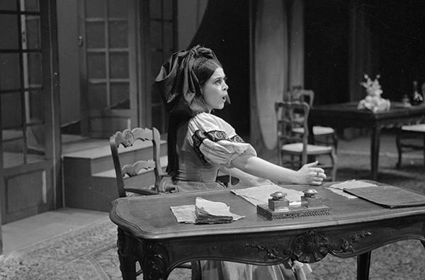 woman singing opera at desk