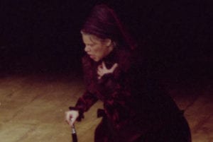 woman singing in opera with cane