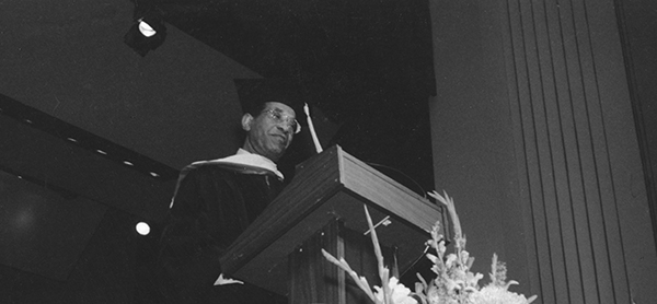 man at graduation lectern