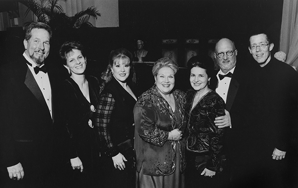 a group of men and women in formal attire