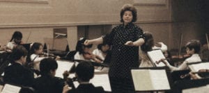 woman conducting children's orchestra