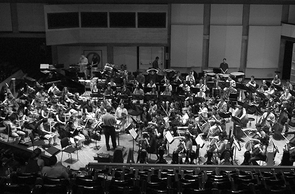 black and white photo of orchestra rehearsing