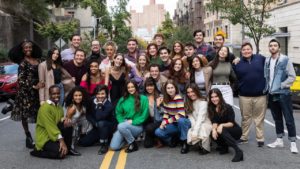 A group of students pose together on a street in New York